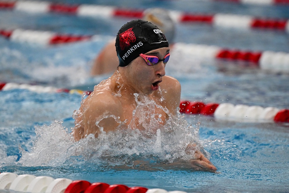 Baylor Perkins swims the breaststroke during a meet.