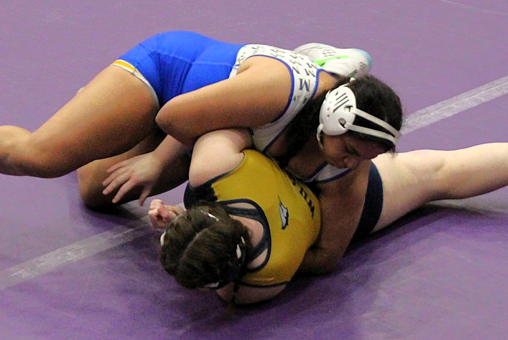 Midland’s Halle Spears, in blue, wrestles during the Girls Wolfpack Challenge. 