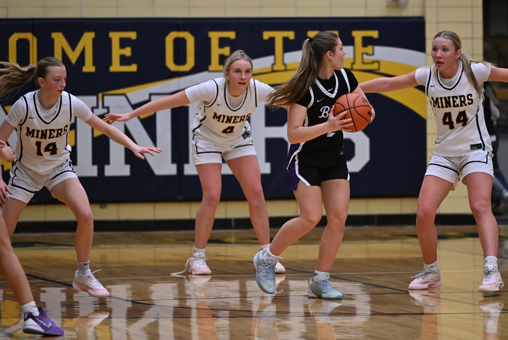 Negaunee's Liliana Saunders (14), Paige O'Donnell (4), and Clare O'Donnell (44) defend Gladstone's Malia Quigley as she seeks an open teammate during the Miners’ 30-19 win last week.
