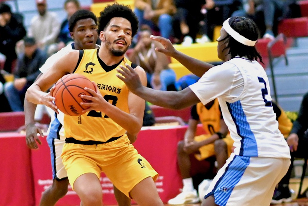 Lansing Waverly’s Derek Thomas (22) works to get to the basket during his team’s 101-76 win over Flint Hamady on Saturday. 