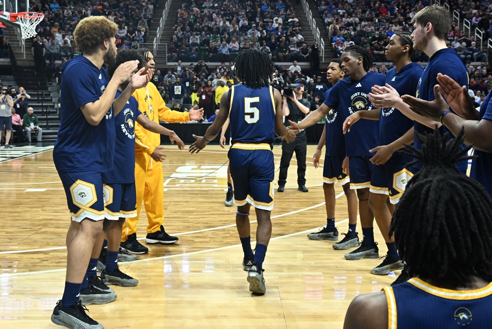 Wayne Memorial’s Jaylohn Allen (5) makes his way through his teammates during introductions before last season’s Division 1 Final at Breslin Center. 