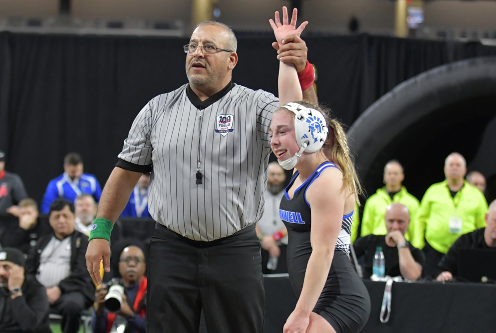 Madison Nieuwenhuis has her hand raised in victory last season at Ford Field.