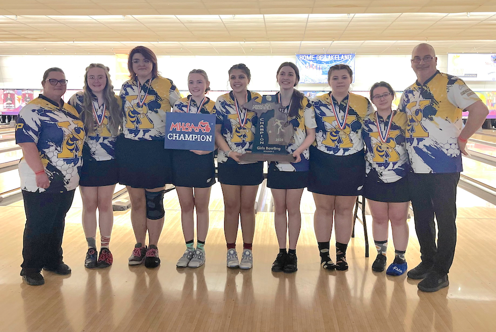 Flint Kearsley stands together for a photo after winning their latest Division 2 title.