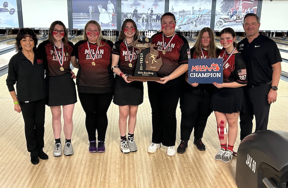 The Milan girls bowling team poses for a photo with their championship trophy.