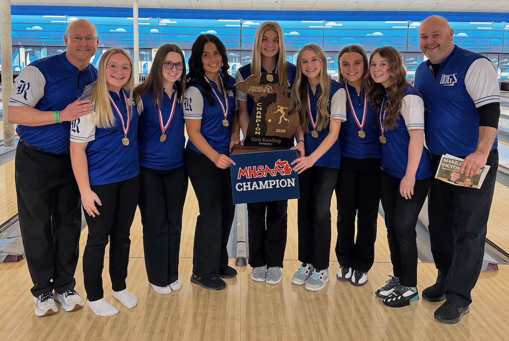 The Ravenna girls bowling team holds up its championship trophy.