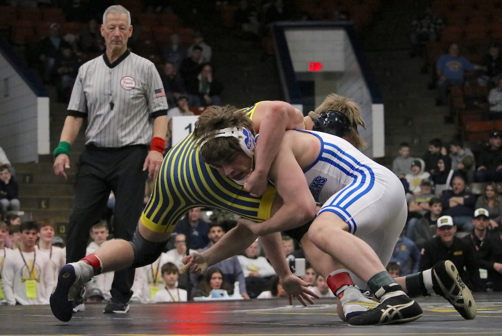 DCC’s Alex Buskirk, front, gets ahold of Ashton Jewel’s leg during their match at 157 pounds Saturday. 