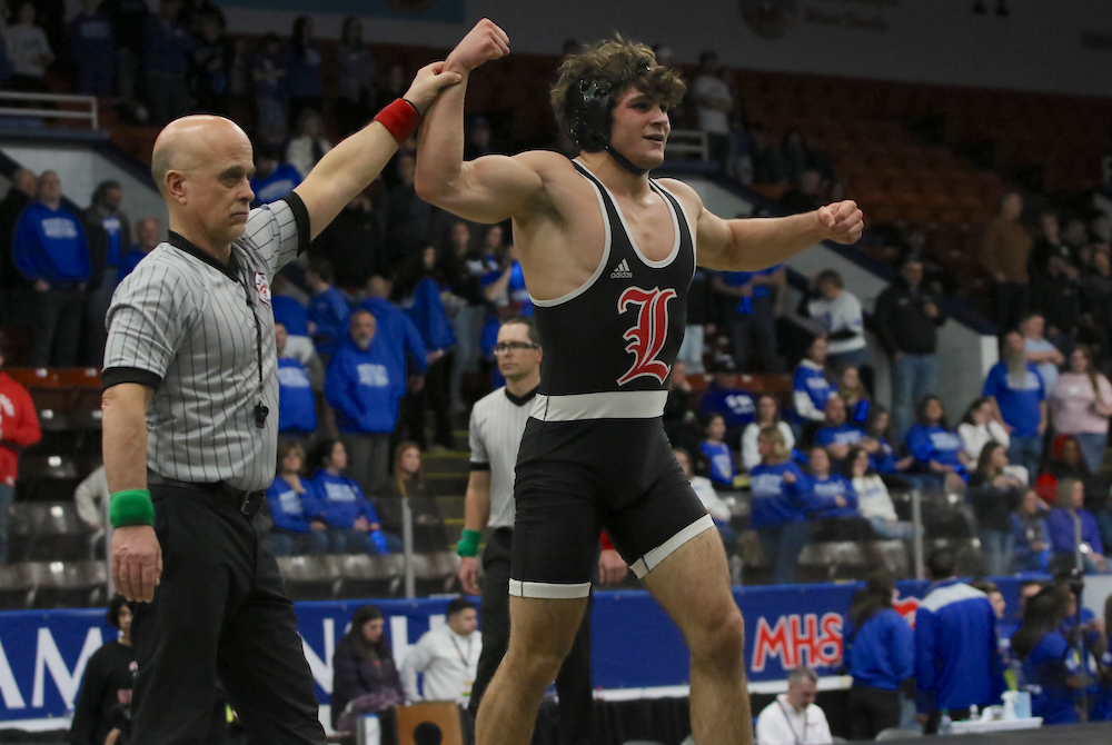 Seth Harvey’s hand is raised in victory as he finishes Lowell’s Division 2 championship win with a technical fall.