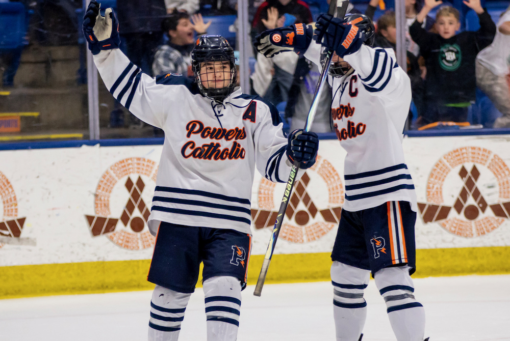 Flint Powers Catholic players celebrate during their Division 2 championship win Saturday at USA Hockey Arena. 