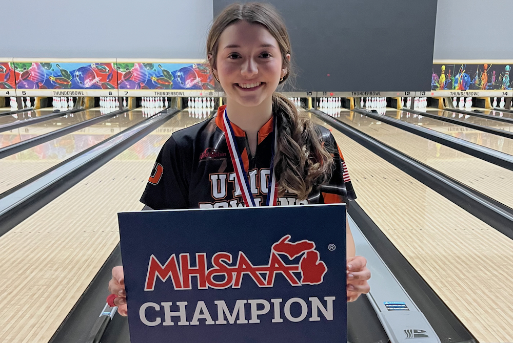 Ava Mazza holds up her championship sign after winning the Division 1 Finals title.