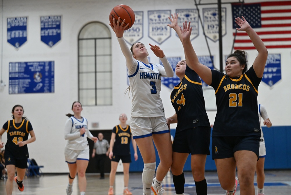 Ishpeming's Jenessa Eagle is defended by Bark River-Harris's Emma Zawada (14) and Melinah Cortez (21) during the Hematites’ 77-45 victory last Tuesday. 
