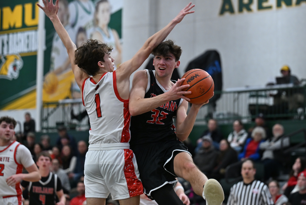 Crystal Falls Forest Park's Vic Giuliani makes a move to get around Marquette's Halen McCollum and take a shot during a loss to the Sentinels on Feb. 17 at Northern Michigan University. 
