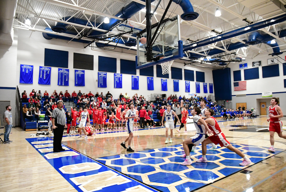 Bath and Laingsburg basketball players position to grab a rebound after a missed shot.