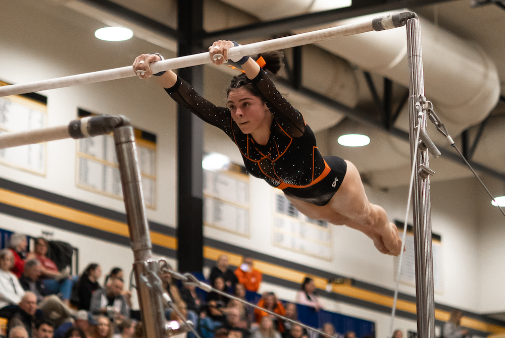  gymnast performs her bars routine during last season’s MHSAA Team Final at Grand Rapids Kenowa Hills.