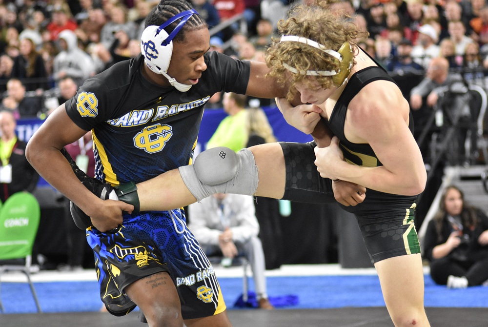 Grand Rapids Catholic Central's Dale Gant, left, wrestles Comstock Park's Logan Whidden on the way to winning his third Individual Finals championship last season at Ford Field.