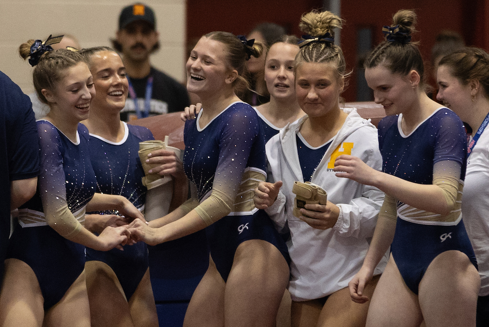 Hartland’s gymnasts share a moment during their rotation on vault at Friday’s MHSAA Team Final. 