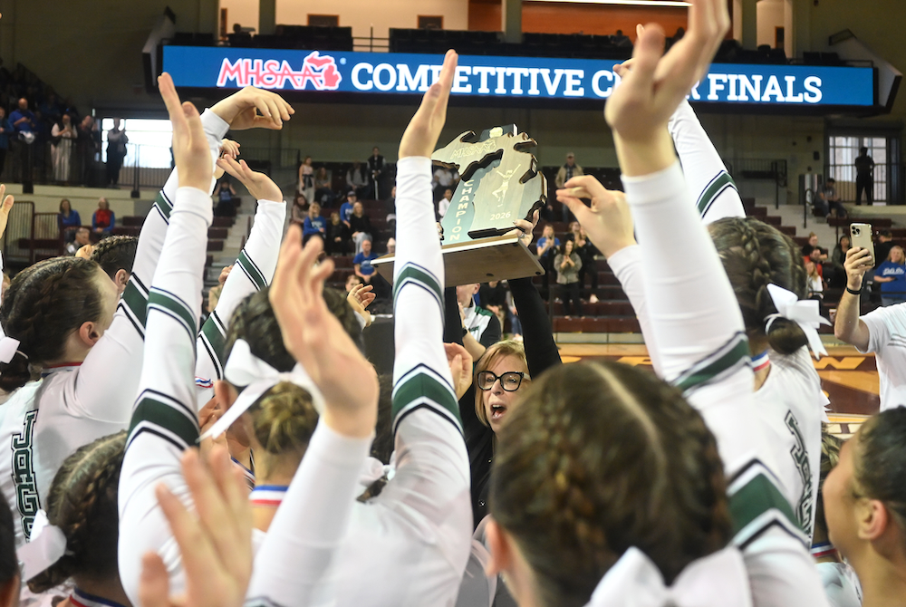 Allen Park coach Julie Goodwin presents the Division 2 championship trophy to her team Saturday. 