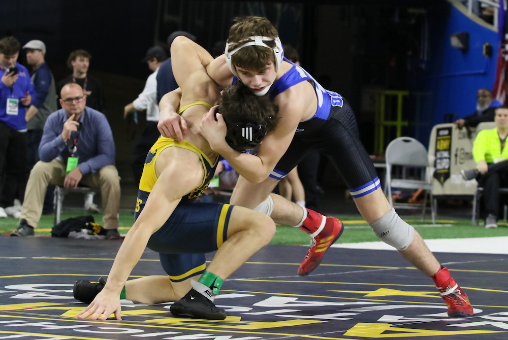 Detroit Catholic Central's Wyatt Lees, top, locks up Grand Ledge's Eden Abdo during their Division 1 championship match Saturday at Ford Field. 