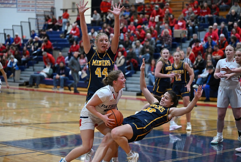 Ishpeming Westwood's Eliisa Doney collides with Negaunee's Keira Waterman as she drives toward the basket during their game Jan. 16, with Clare O'Donnell (44) also defending. 