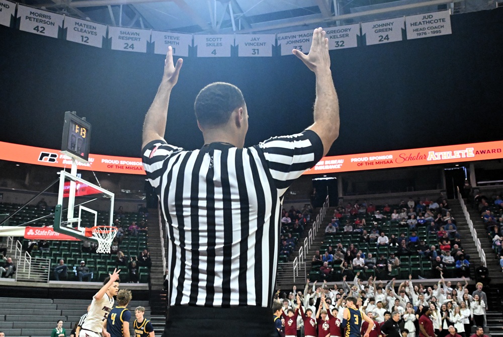 A referee signals a made shot during last season's MHSAA Boys Basketball Finals weekend. 