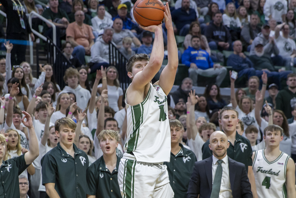 Freeland’s bench waits in hopeful anticipation as Wilson Huckeby shoots a 3-pointer Friday at Breslin Center.