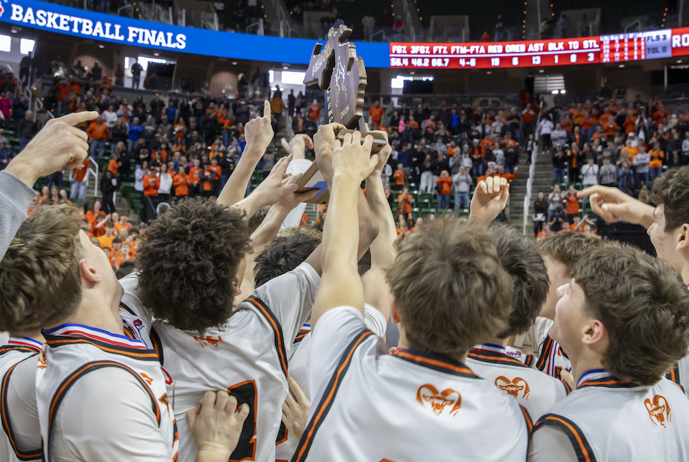 Rockford players raise their championship trophy after winning the Division 1 championship Saturday at Breslin Center. 