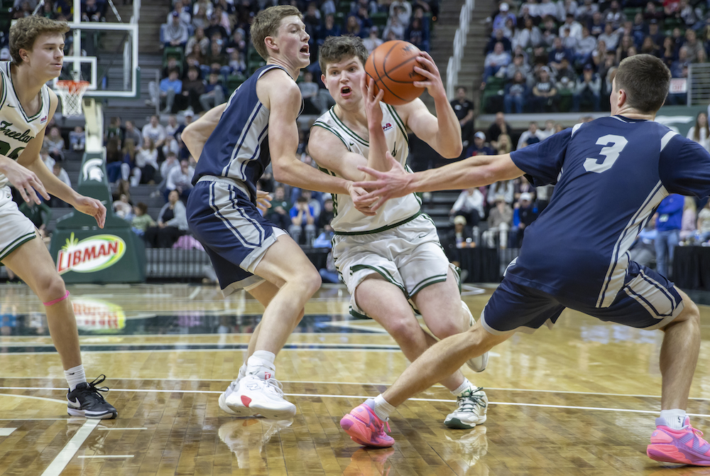 Freeland’s Wilson Huckeby attempts to cut between a pair of Unity Christian defenders during the Division 2 Final on Saturday.