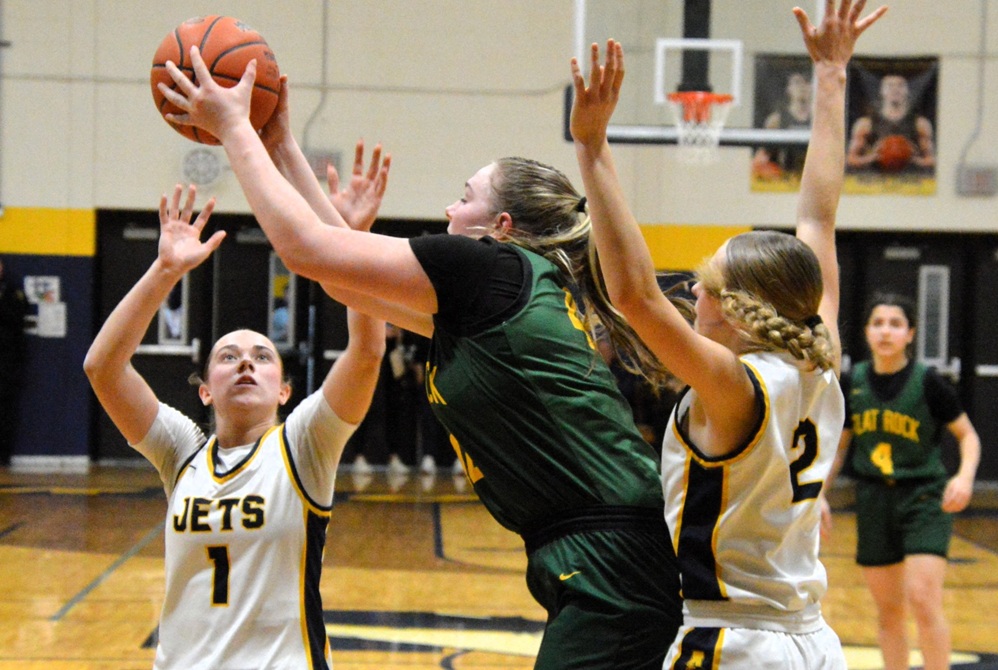 Carleton Airport’s Delaney Zajac (1) and Olivia Gratz (2) defend the post against Flat Rock. 