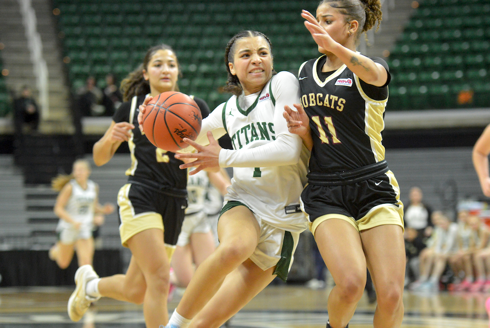 Lumen Christi’s Kenna Hunt works to get to the basket with Brandywine’s Lily Gill (11) defending Thursday.