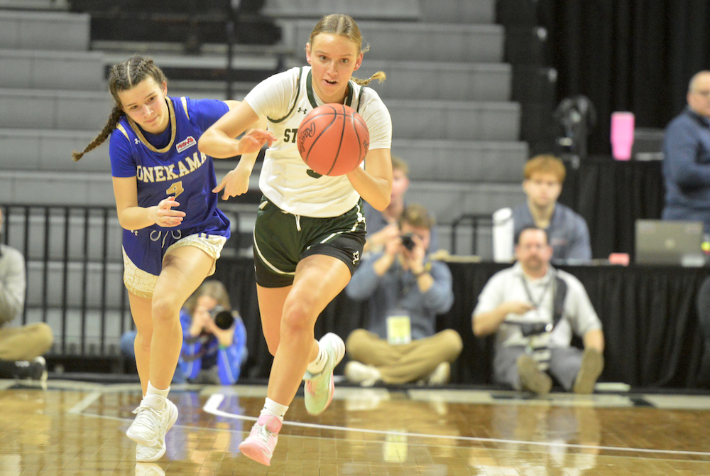 Portland St. Patrick’s Gracelyn Rockey pushes the pace as Onekama’s Callie Sinke keeps stride during Thursday’s Semifinal at Breslin Center. 