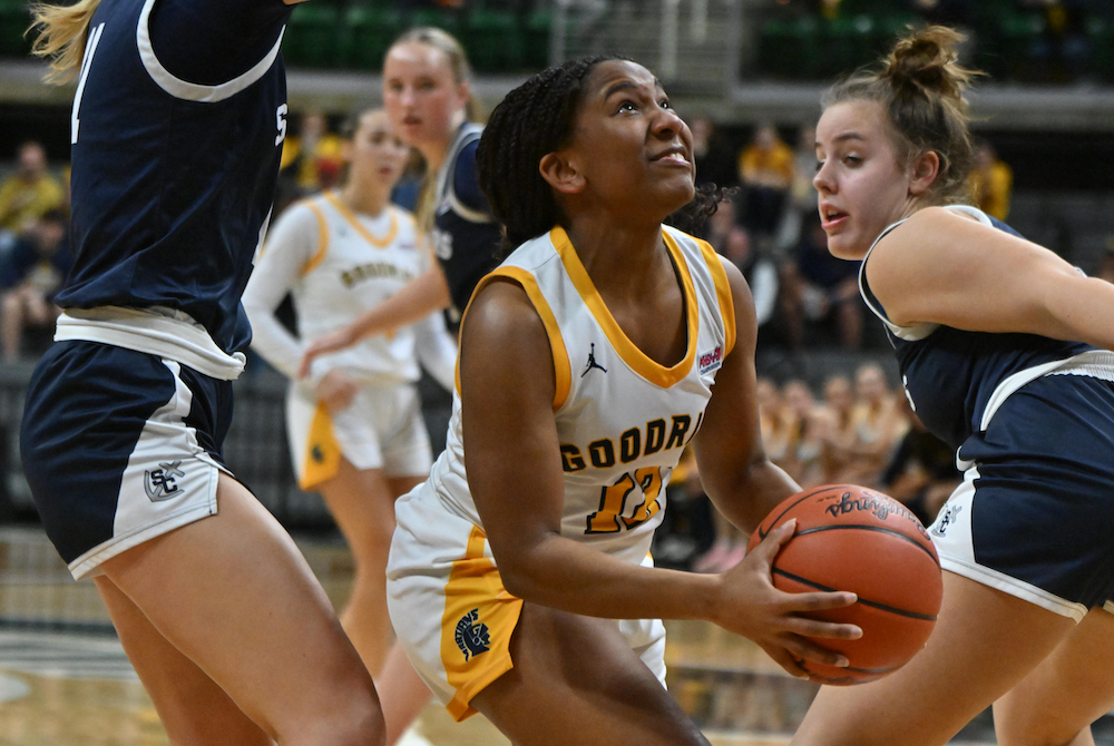 Goodrich’s Kayla Hairston splits a pair of South Christian defenders driving to the hoop Friday. 
