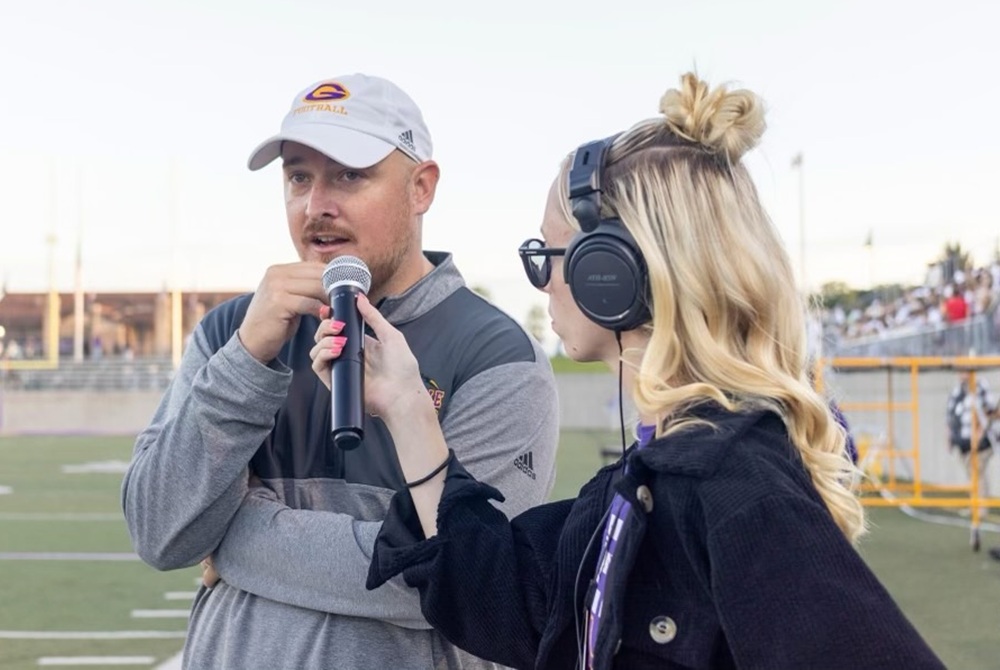  Gracelin Martin interviews Greenville football coach Scott McDougall during a game this past season. 
