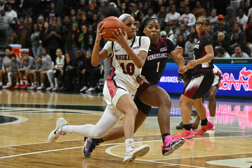 Muskegon’s Mariah Sain (10) drives hard to the basket Saturday with Renaissance’s Maria Walker (1) keeping in step. 