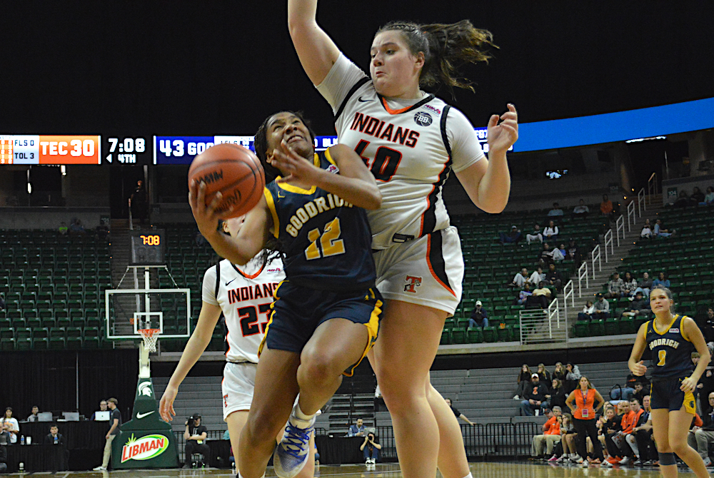 Goodrich’s Kayla Hairston (12) drives to the basket as Tecumseh’s Addi Zajac (40) goes for a block during Saturday’s Division 2 Final at Breslin Center.