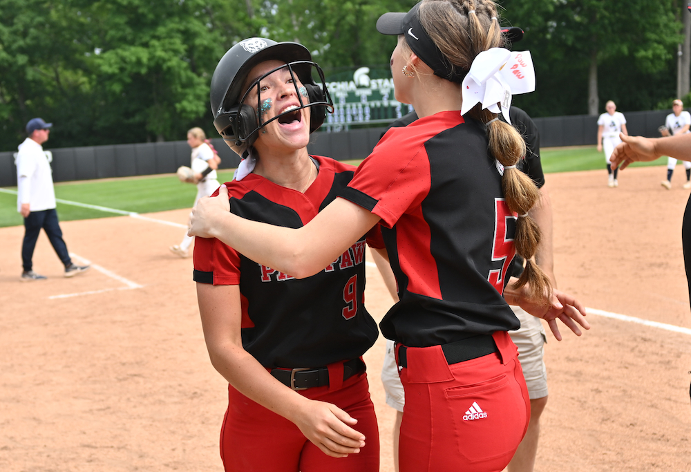 Paw Paw's Elizabeth Vanderburg (9) and Carlie Streich embrace after Vanderburg's walk-off home run in last season's Semifinal. 