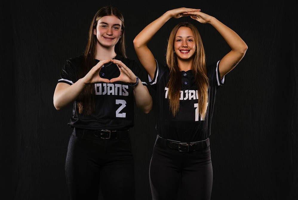 Traverse City Central pitcher Piper Cavanaugh, left, and catcher Grace Cary pose for a photo together while making Os for Oregon and Ohio State. 