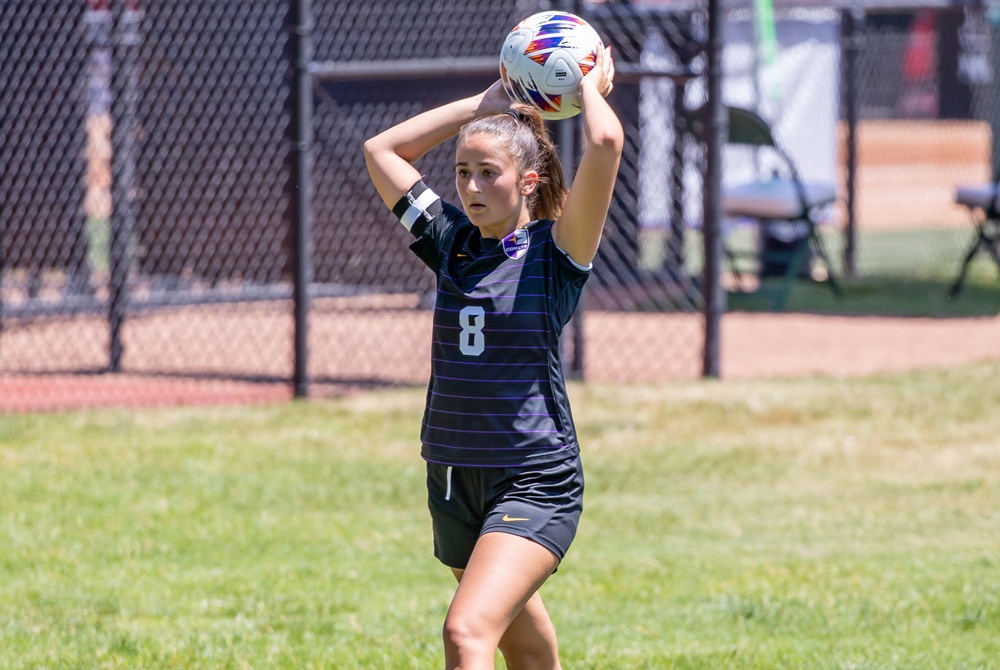 A player throws in the soccer ball during a 2024 championship game. 