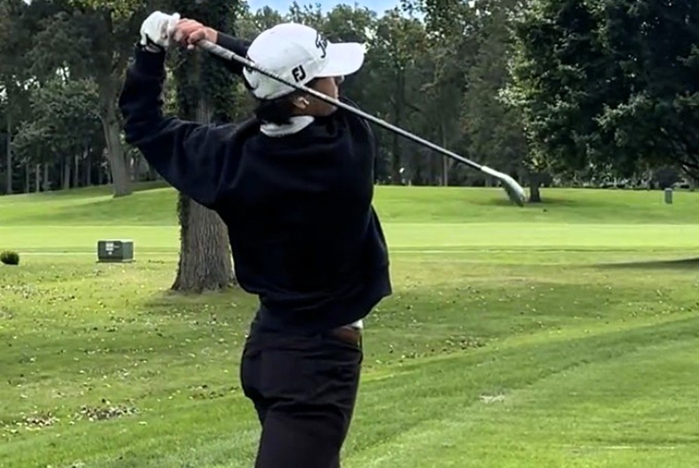 Taleon Guess watches one of his golf shots. 