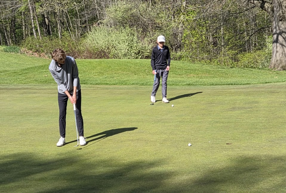 Kalamazoo Christian’s Max Nobis follows his putt as it approaches the cup.