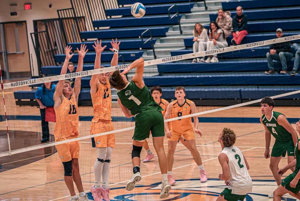 Jenison’s Quinn Cochran (1) winds up for a kill attempt against Hudsonville this season. 