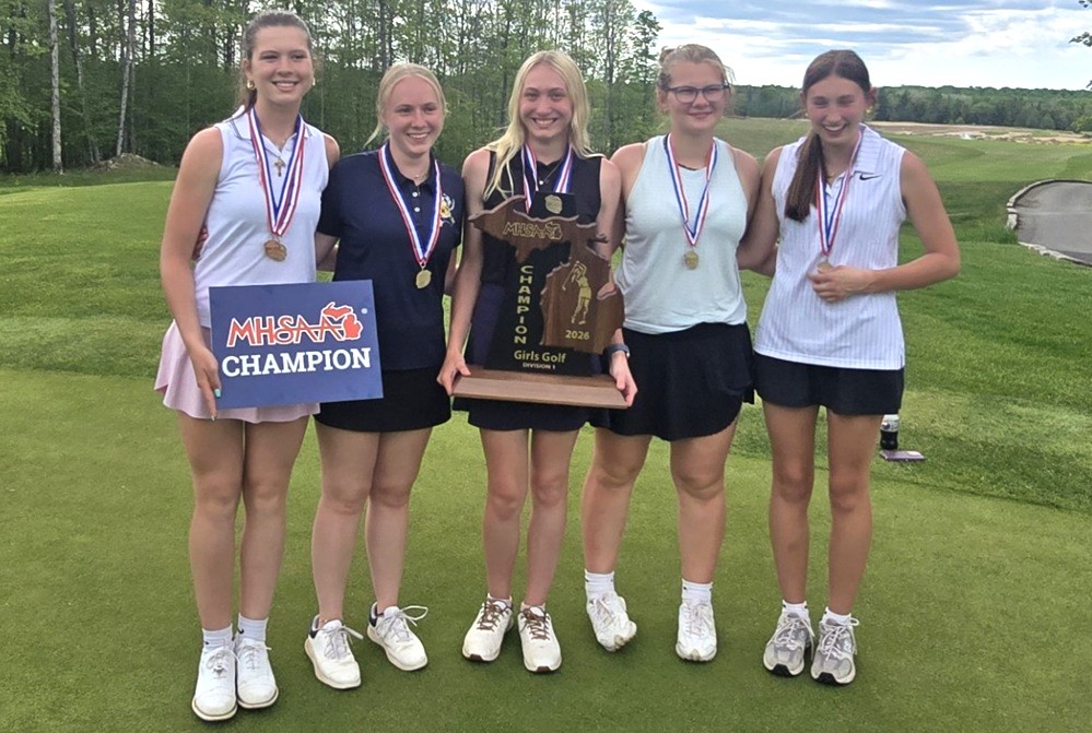 The Negaunee girls golf team poses for a photo with their championship trophy.
