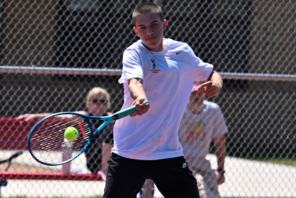 Marquette’s Lucas Belkovich drives a forehand during a match at No. 1 singles Wednesday. 