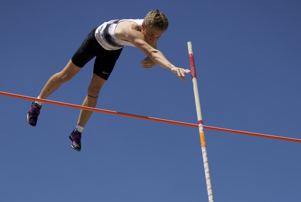 East Kentwood's Reece Emeott clears the bar during a pole vault Saturday. 