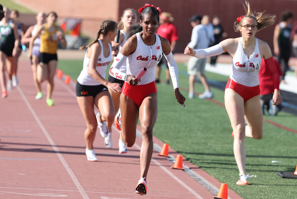 Oak Park's Nevaeh Burns bursts forward after taking a handoff during for her team's winning 1,600 relay Saturday. 