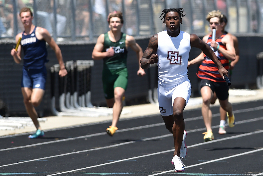 Harper Woods' DeAndre Bidden sprints to the finish ahead of the field in the 800 relay Saturday. (