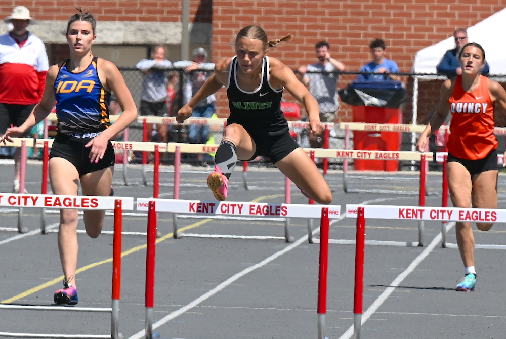 Olivet's Emily Peters, center, clears a hurdle on the way to a runner-up finish in the 100 hurdles race Saturday.