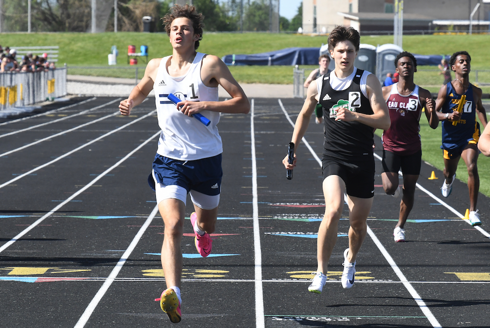 Hillsdale Academy's Dawson Scharer, far left, carries the baton in the 1,600 relay Saturday.
