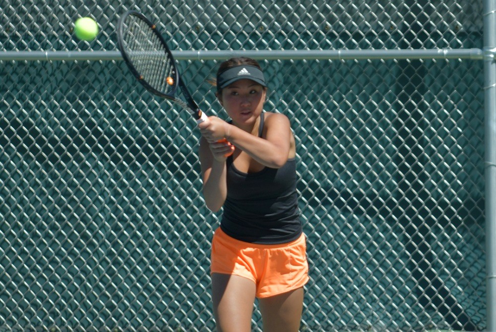 A Northville doubles player returns a volley Saturday.