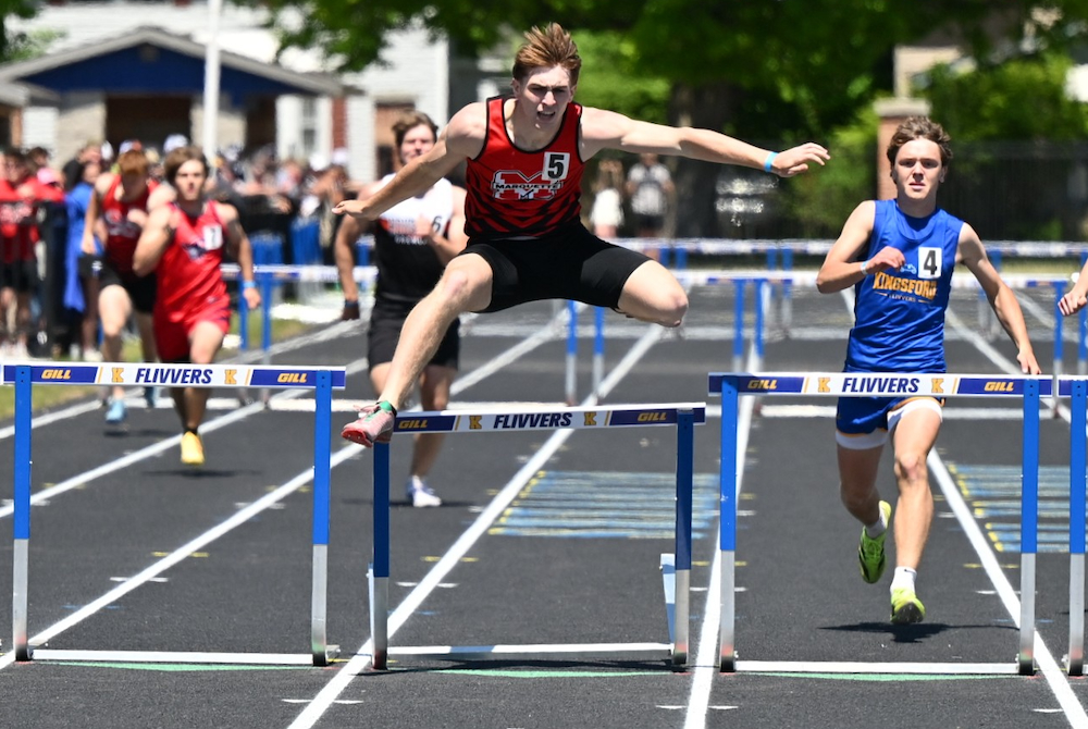 Marquette's Ford Richardson catches his heel on the last hurdle, but he is still able to get the victory just ahead of Kingsford's Sid Olson. 