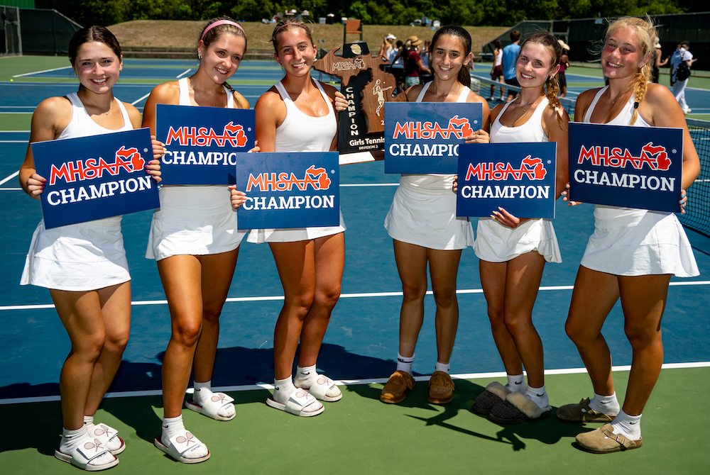 Birmingham Seaholm’s six flight winners stand together for a photo with the championship trophy Thursday at Midland Tennis Center. 