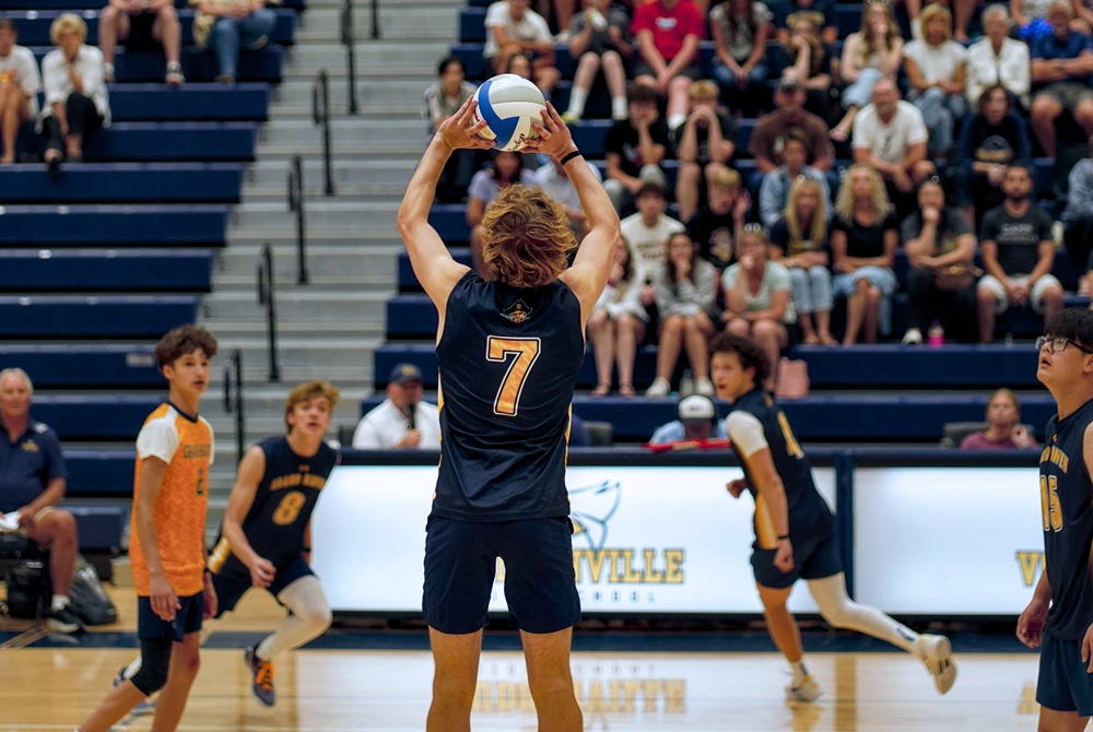 Grand Haven’s Caleb Cryst (7) sets his team’s offense during a 3-0 Division 1 Quarterfinal win over Hudsonville on Wednesday.